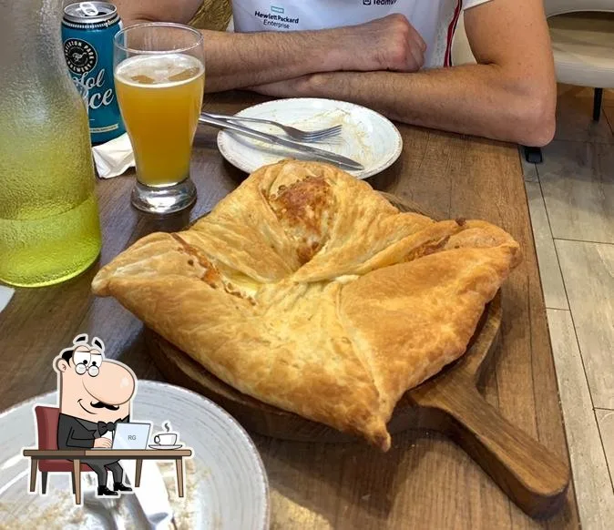 Diner sitting beside Georgian khachapuri at Tiflisi in Toronto
