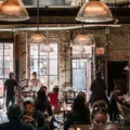 A group of people talking in a bright coffee shop