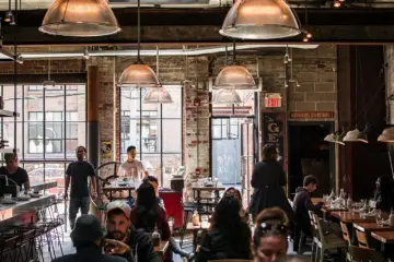 A group of people talking in a bright coffee shop