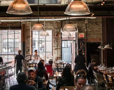 A group of people talking in a bright coffee shop