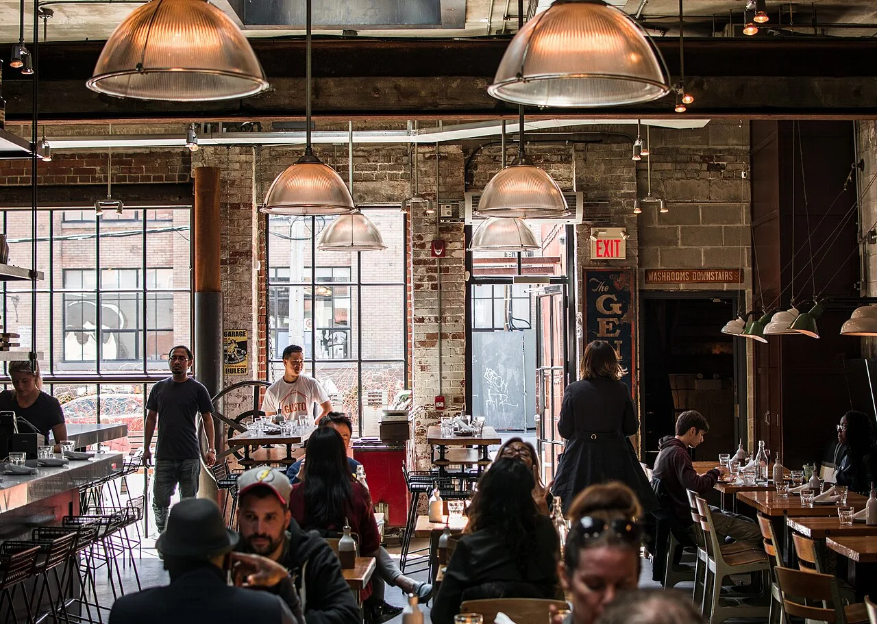 A group of people talking in a bright coffee shop