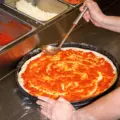 A fresh pizza being prepared at Pizzaiolo