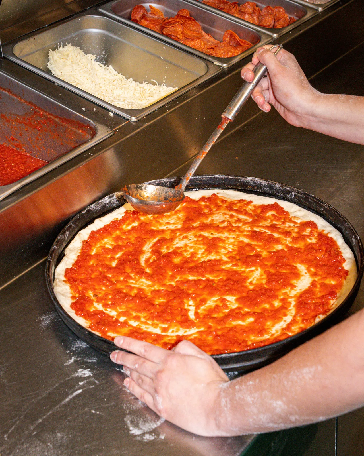 A fresh pizza being prepared at Pizzaiolo