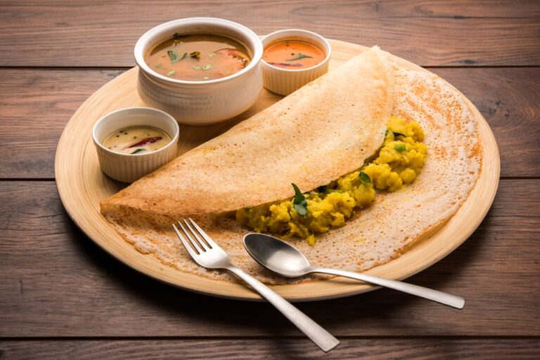 A South Indian masala dosa served with sambar and chutneys