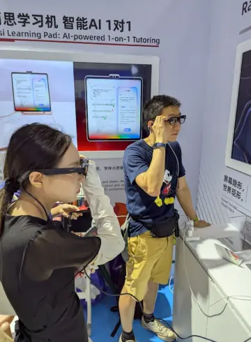 A woman and a man trying camera-equipped smart glasses at a technology exhibition