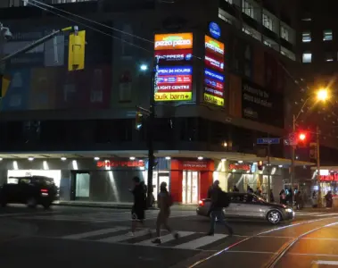 Toronto transit and pedestrians near College Street at night
