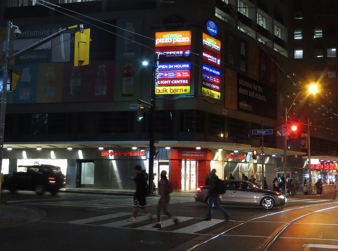 Toronto transit and pedestrians near College Street at night