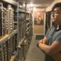 Tonality Records owner beside shelves of vintage audio receivers