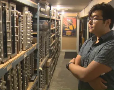 Tonality Records owner beside shelves of vintage audio receivers