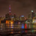 Toronto skyline and tall condo towers reflected in the water at night