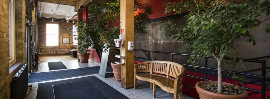 Brick lobby with plants inside 401 Richmond in Toronto