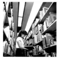 A woman standing between book stacks in the AGO library