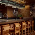 Warm shelves, tables and bar seating inside Book Bar in Mirvish Village
