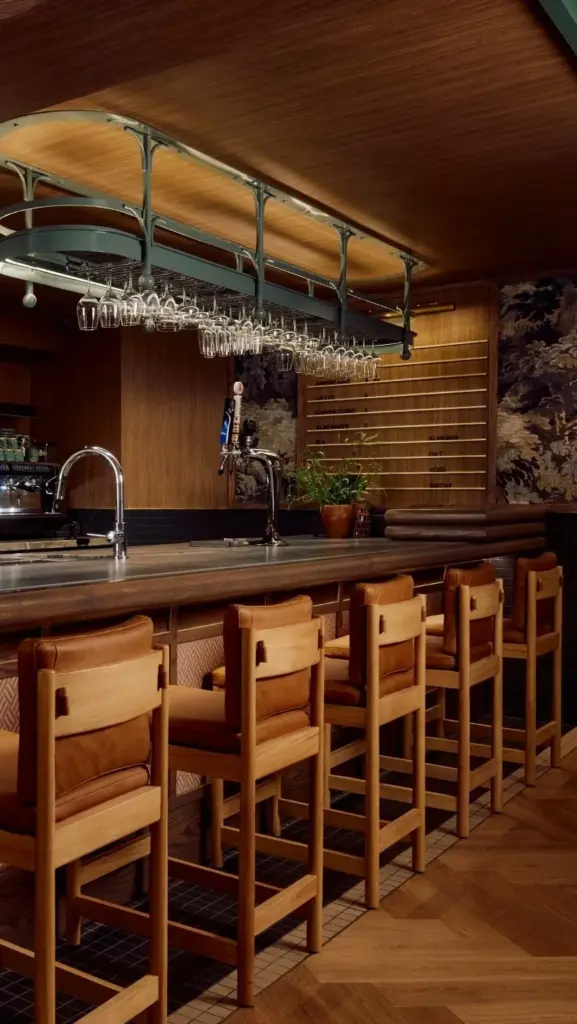 Warm shelves, tables and bar seating inside Book Bar in Mirvish Village