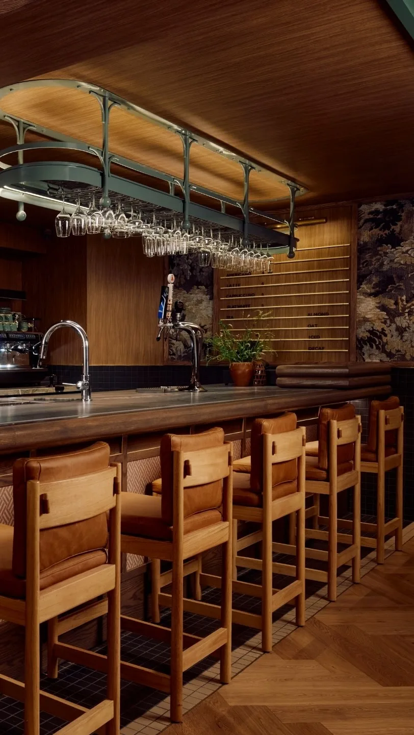 Warm shelves, tables and bar seating inside Book Bar in Mirvish Village