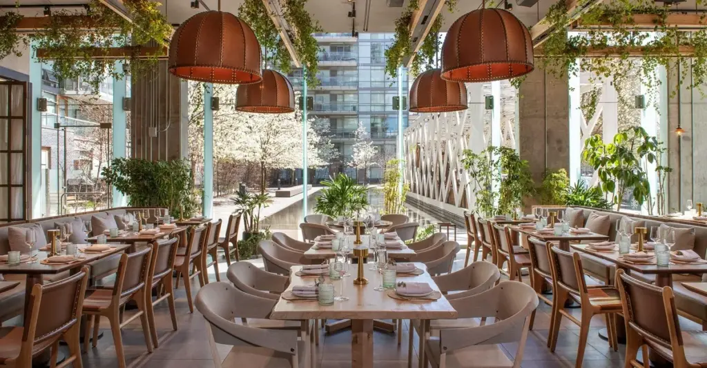 Bright dining room with moveable tables and chairs at Casa Madera Toronto