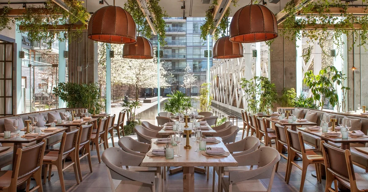 Bright dining room with moveable tables and chairs at Casa Madera Toronto