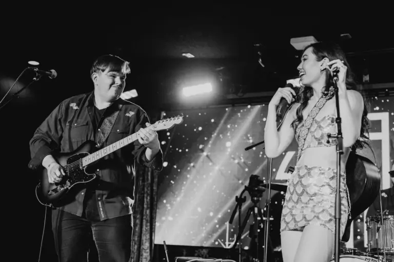 Singer and guitarist performing on stage at El Mocambo