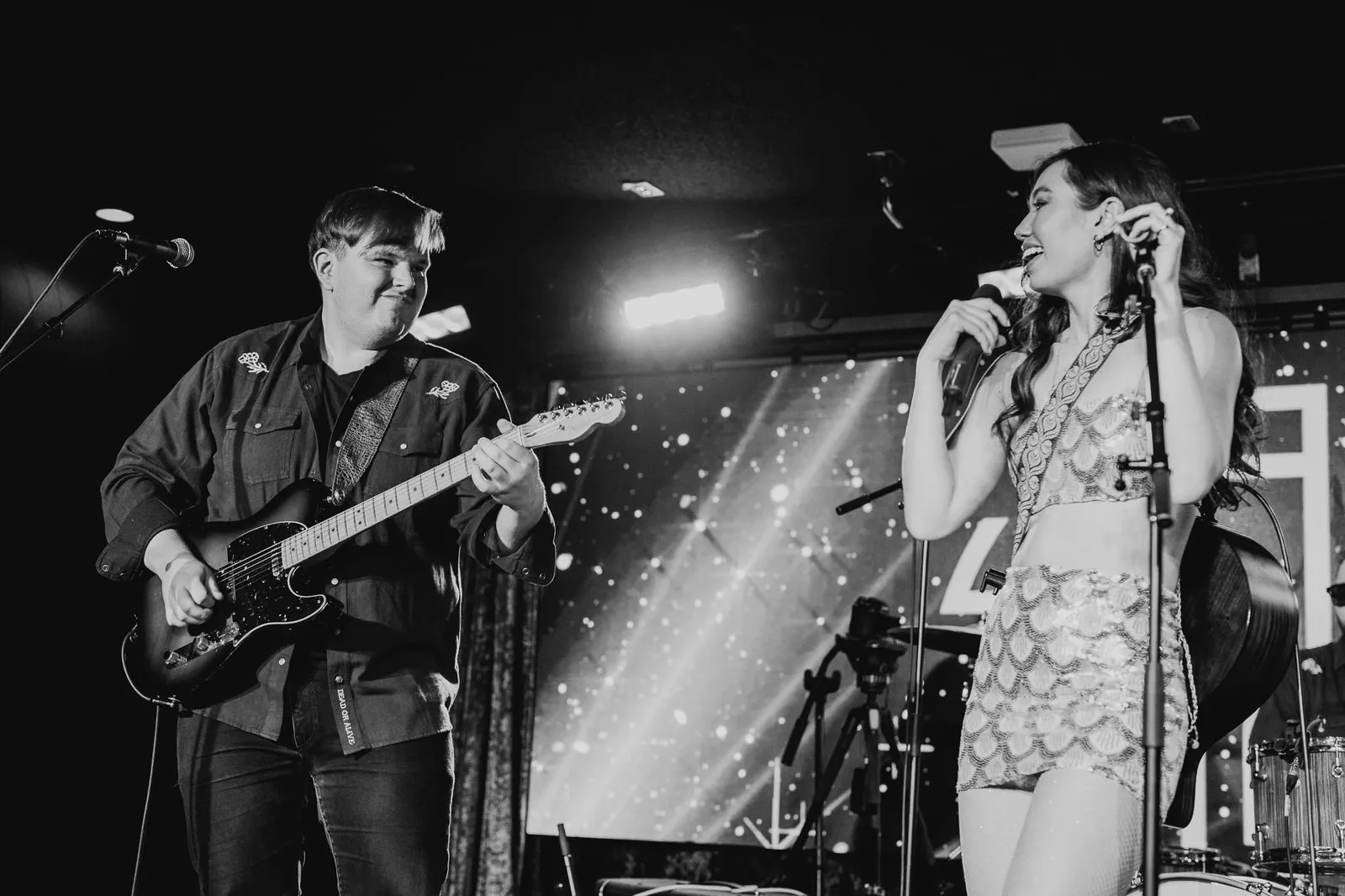 Singer and guitarist performing on stage at El Mocambo