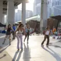 People gathering and roller skating at a summer event under the Gardiner in Toronto
