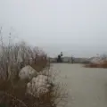 A person fishing from the Toronto waterfront near the Hearn Generating Station