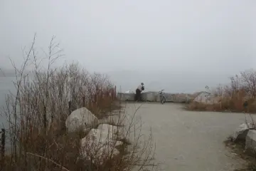 A person fishing from the Toronto waterfront near the Hearn Generating Station