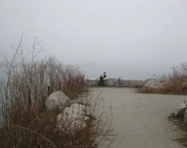 A person fishing from the Toronto waterfront near the Hearn Generating Station
