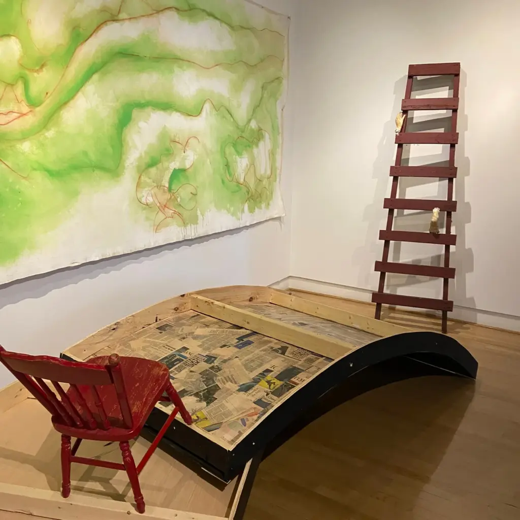 Art, books and a red chair inside Gallery Arcturus