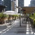 Tables, umbrellas and plants on the rooftop garden at 401 Richmond in Toronto