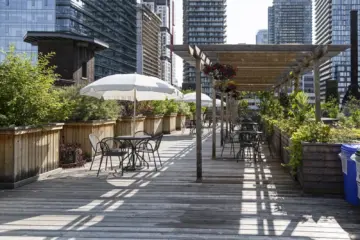 Tables, umbrellas and plants on the rooftop garden at 401 Richmond in Toronto