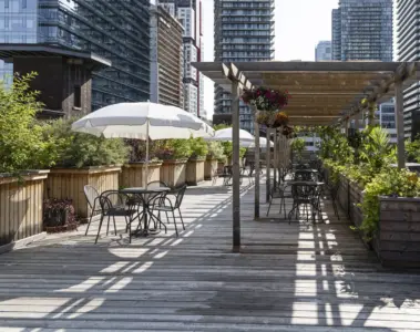 Tables, umbrellas and plants on the rooftop garden at 401 Richmond in Toronto