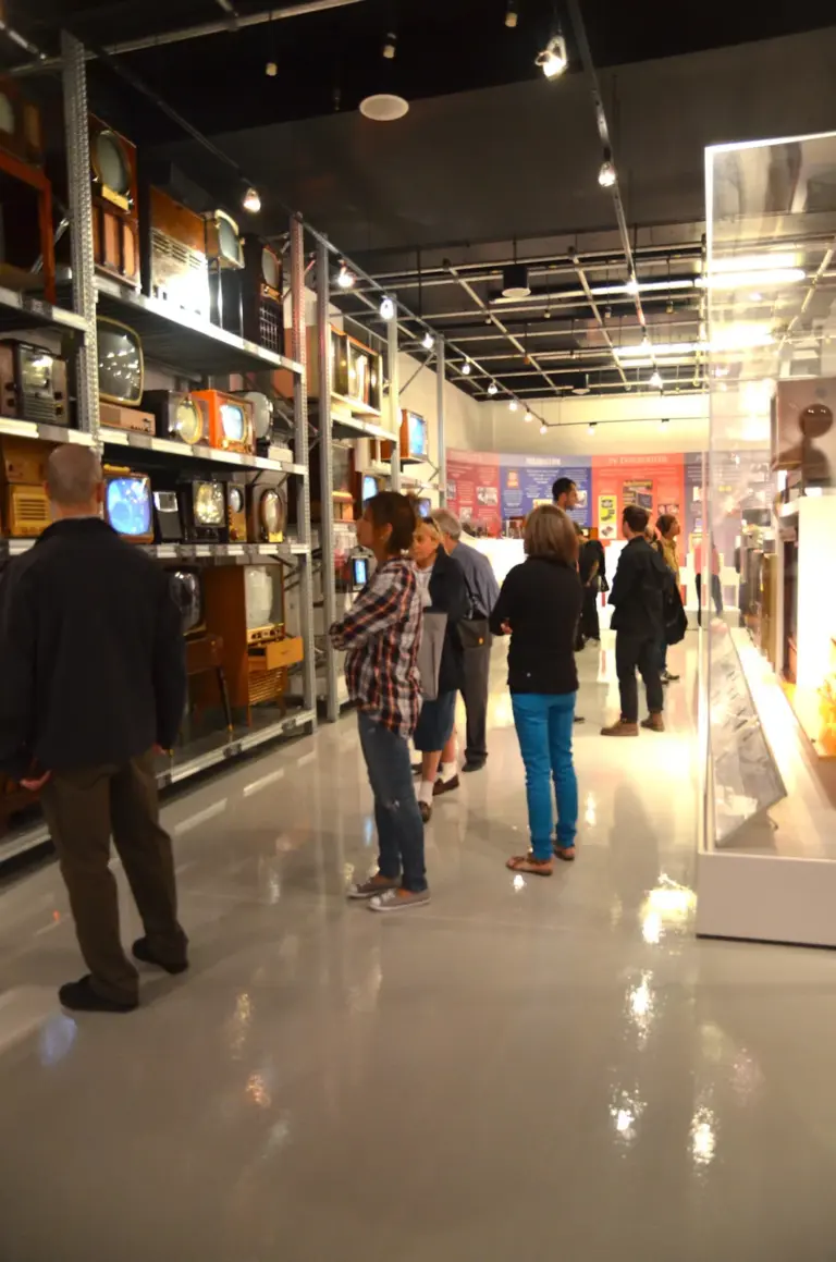 Visitors looking at vintage television sets inside MZTV in Toronto