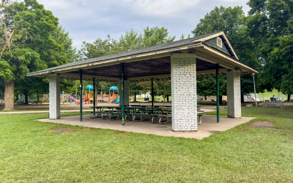 A large covered picnic shelter beside the playground at Christie Pits Park