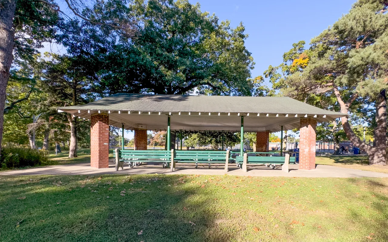 Covered Picnic Site 15 with tables on a lawn in High Park