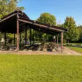 A large open picnic shelter with rows of tables at Thomson Memorial Park