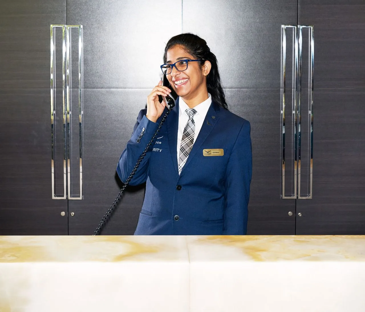 A Toronto condo concierge answering the phone at the front desk