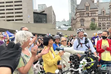 Olivia Chow stands with cyclists outside Toronto City Hall on the day she took office as mayor