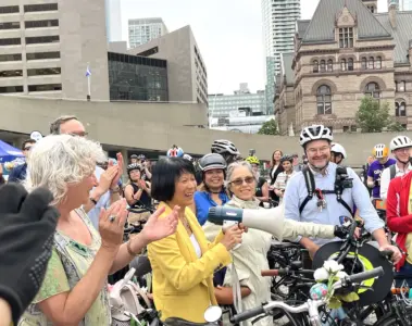 Olivia Chow stands with cyclists outside Toronto City Hall on the day she took office as mayor