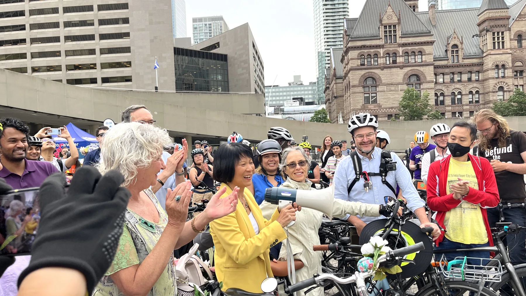 Olivia Chow stands with cyclists outside Toronto City Hall on the day she took office as mayor