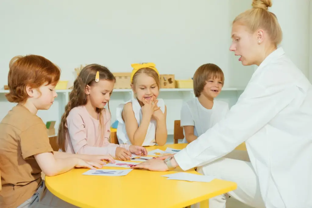 Teacher and young children working together around a classroom table