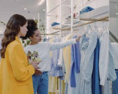 Two women choosing dresses in a clothing store