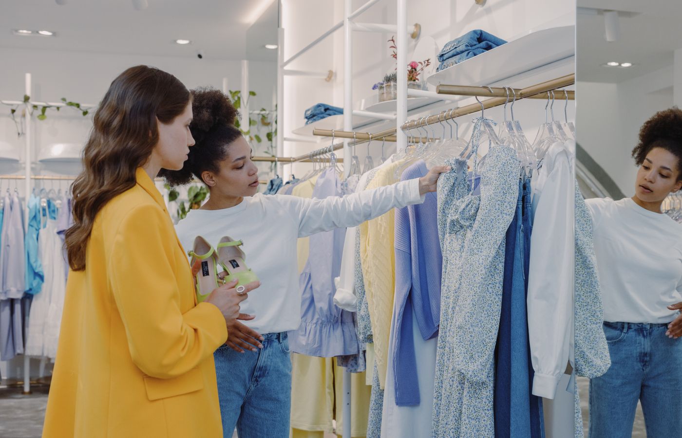 Two women choosing dresses in a clothing store