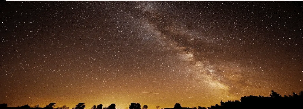 The Milky Way over a dark treeline at North Frontenac Astronomy Park