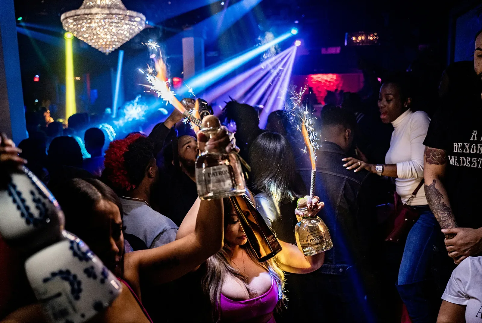 A diverse group celebrates with bottle service inside SU Karaoke