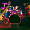 Two musicians play guitars inside a rehearsal studio at The Best Deal in Town