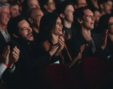 A diverse audience smiles and applauds inside a TIFF cinema