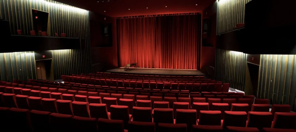 An empty cinema with red seats and a red curtain inside TIFF Lightbox