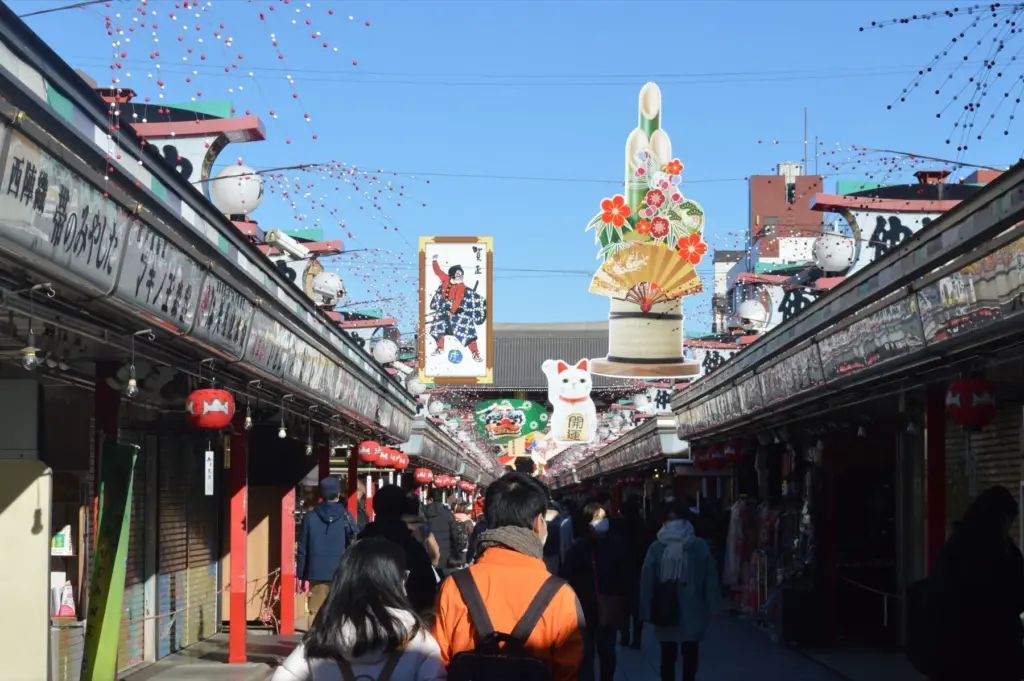 Crowded Nakamise shopping street in Asakusa with colourful seasonal decorations