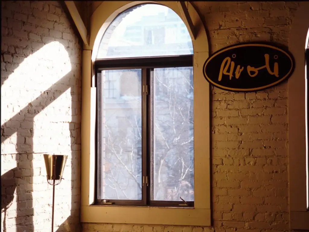 Sunlight, brick walls and a bar sign inside the Rivoli on Queen Street West