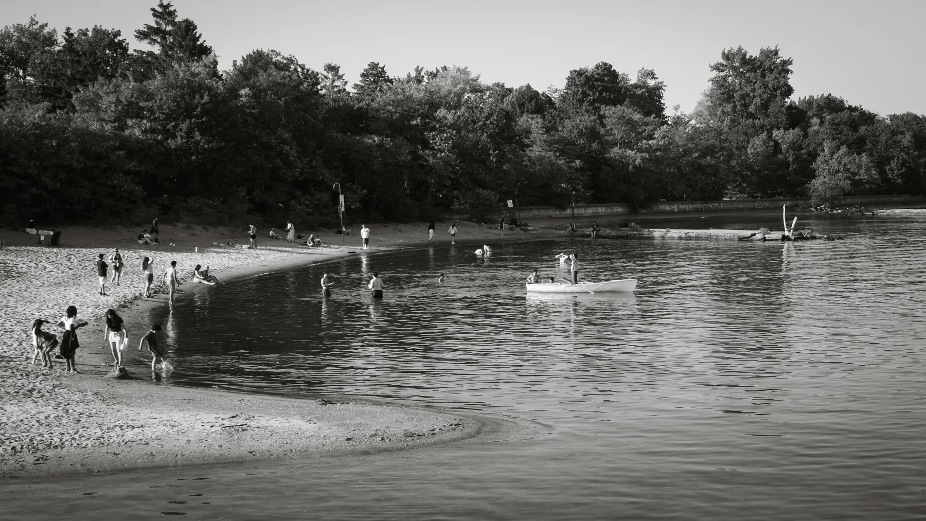 People enjoying a calm summer beach on Centre Island in Toronto